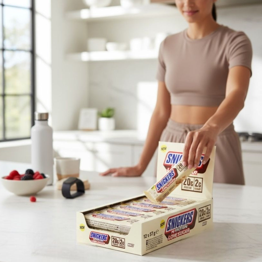 pack de 12 barres de Snickers Hi-Protein Low Sugar White sur une table à manger